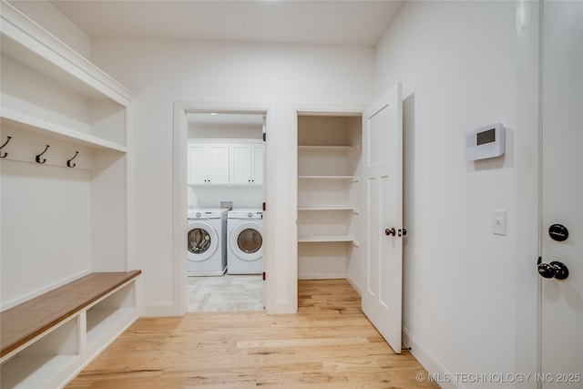 6904 E 86th Pl N, Owasso, OK 74055 - laundry room with separate washer and dryer, light wood-style flooring, and cabinet space