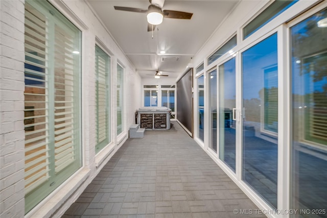 6904 E 86th Pl N, Owasso, OK 74055 - unfurnished sunroom with ceiling fan and brick patterned flooring