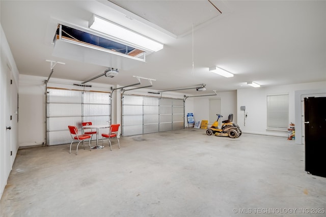 6904 E 86th Pl N, Owasso, OK 74055 - garage featuring a garage door opener