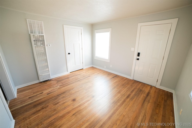 2705 E Ute St, Tulsa, OK 74110 - unfurnished bedroom featuring a heating unit and light wood-style floors