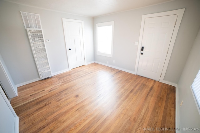 2705 E Ute St, Tulsa, OK 74110 - unfurnished bedroom with a heating unit and light wood-style floors