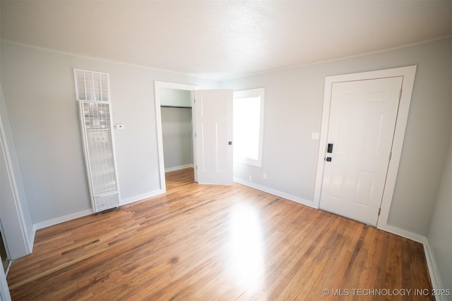 2705 E Ute St, Tulsa, OK 74110 - unfurnished bedroom with light wood-type flooring, a heating unit, and a closet