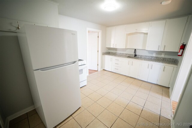 2705 E Ute St, Tulsa, OK 74110 - kitchen with white appliances, ornamental molding, white cabinetry, and light tile patterned floors