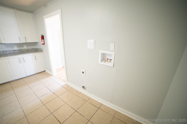 2705 E Ute St, Tulsa, OK 74110 - laundry area featuring hookup for a washing machine, electric dryer hookup, cabinet space, and light tile patterned flooring