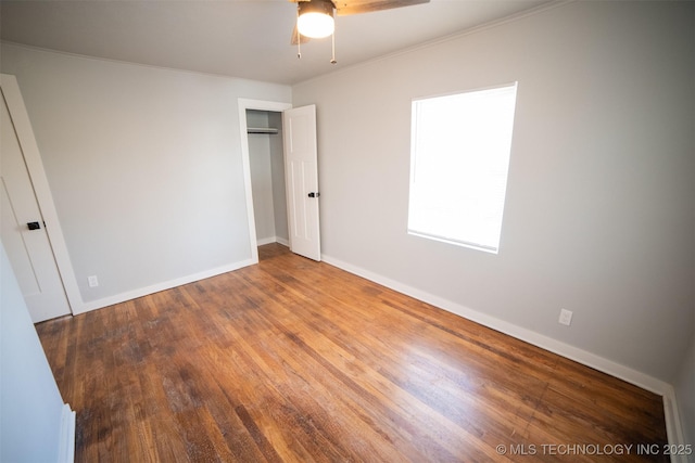 2705 E Ute St, Tulsa, OK 74110 - unfurnished bedroom with wood finished floors, a closet, ornamental molding, and a ceiling fan