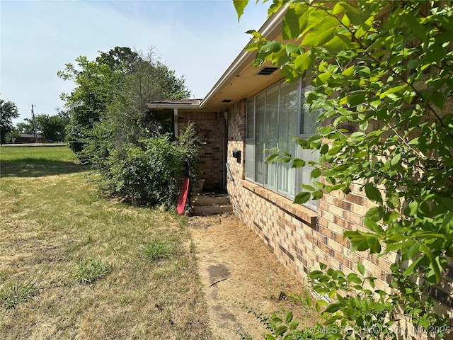 1581 S Velma, Atoka, OK 74525 - view of home's exterior featuring brick siding and a lawn