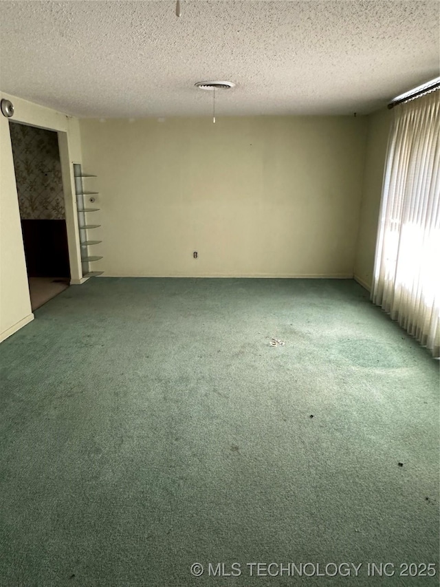 1581 S Velma, Atoka, OK 74525 - unfurnished room with carpet floors and a textured ceiling