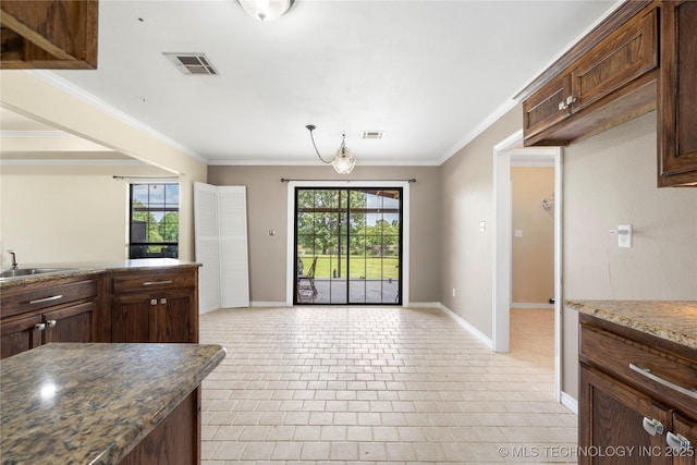 5764 S Carr, Pen, OK 74525 - kitchen with crown molding, dark brown cabinetry, and light tile patterned floors