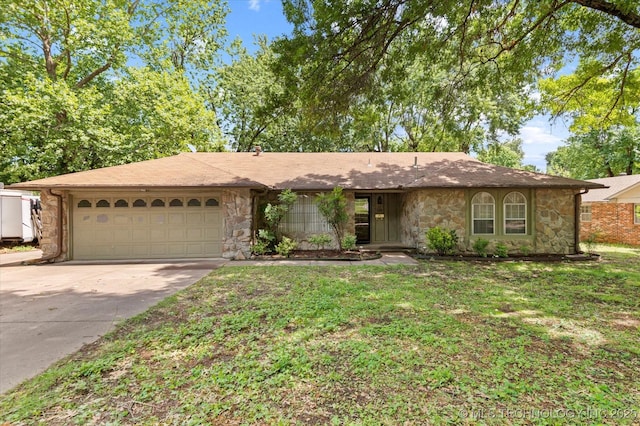 1020 Lariat Dr, Bartlesville, OK 74006 - ranch-style house with a garage, driveway, stone siding, and a front lawn