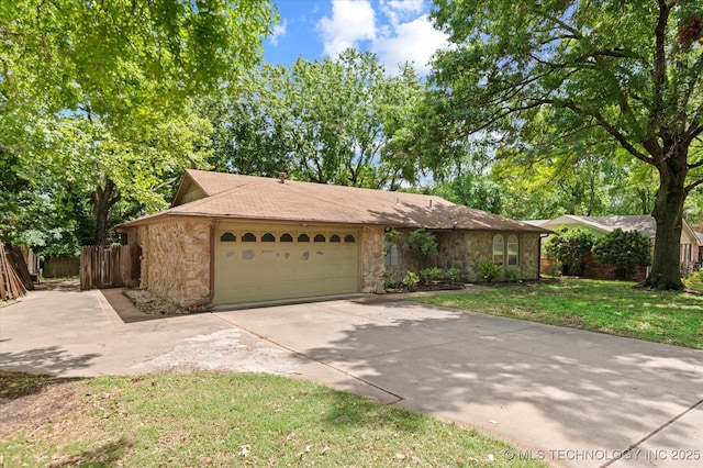 1020 Lariat Dr, Bartlesville, OK 74006 - view of front of house featuring stone siding, a garage, and concrete driveway