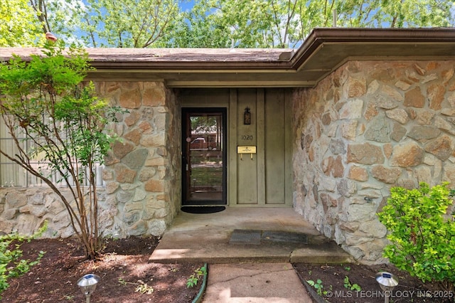 1020 Lariat Dr, Bartlesville, OK 74006 - doorway to property featuring stone siding