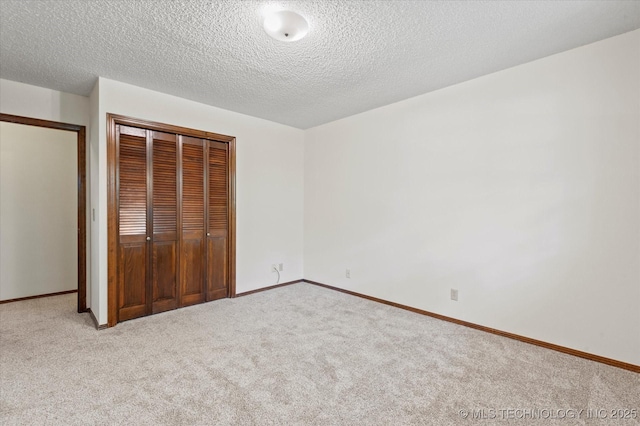 1020 Lariat Dr, Bartlesville, OK 74006 - unfurnished bedroom with carpet flooring, a textured ceiling, and a closet