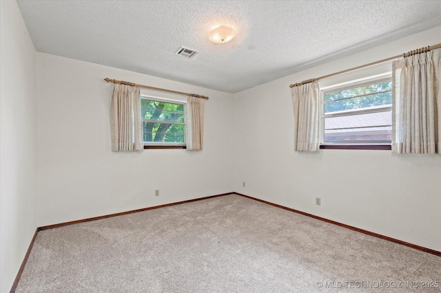 1020 Lariat Dr, Bartlesville, OK 74006 - carpeted empty room featuring a textured ceiling and baseboards