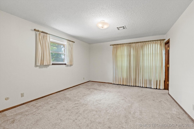 1020 Lariat Dr, Bartlesville, OK 74006 - carpeted spare room featuring baseboards and a textured ceiling