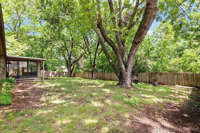 1020 Lariat Dr, Bartlesville, OK 74006 - fenced backyard with a sunroom