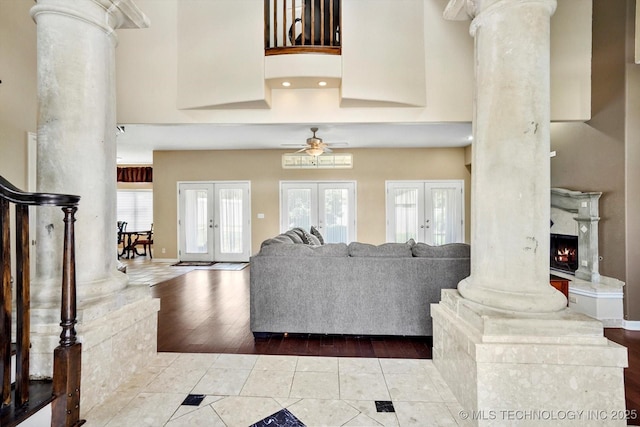 524 S 67th St, Broken Arrow, OK 74014 - living room featuring ornate columns, french doors, a high ceiling, wood finished floors, and ceiling fan