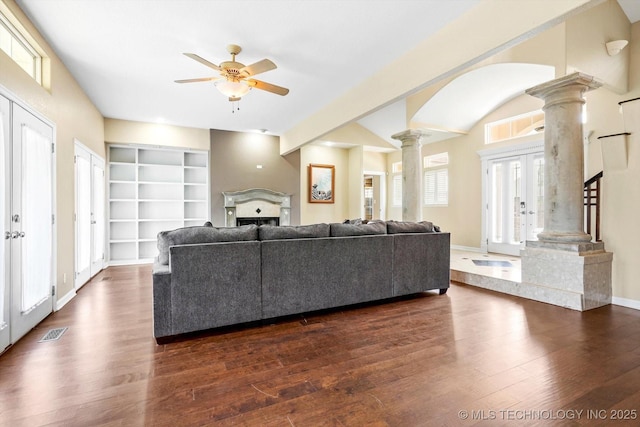 524 S 67th St, Broken Arrow, OK 74014 - living room featuring decorative columns, a ceiling fan, dark wood-style floors, and a fireplace