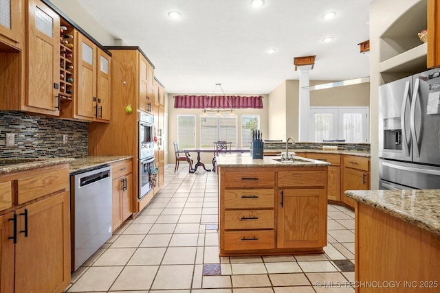 524 S 67th St, Broken Arrow, OK 74014 - kitchen featuring appliances with stainless steel finishes, backsplash, light tile patterned floors, light stone counters, and recessed lighting
