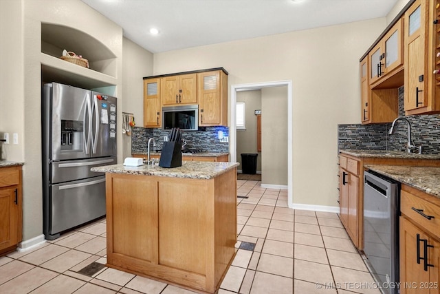 524 S 67th St, Broken Arrow, OK 74014 - kitchen with appliances with stainless steel finishes, backsplash, a center island with sink, and light tile patterned flooring