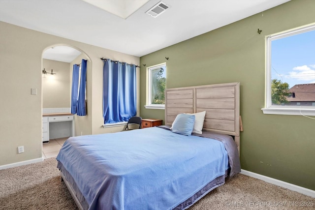 524 S 67th St, Broken Arrow, OK 74014 - carpeted bedroom with baseboards and arched walkways