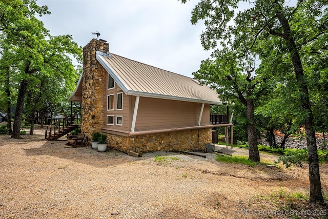 2676 Masters, Sulphur, OK 73086 - view of side of home with a chimney, stone siding, stairway, and a metal roof