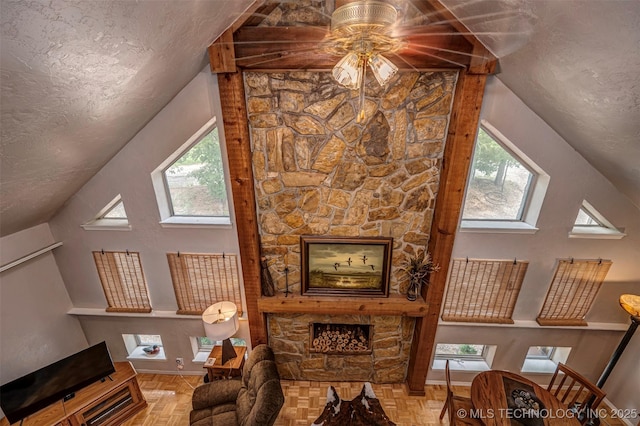 2676 Masters, Sulphur, OK 73086 - living room with a fireplace, vaulted ceiling, a ceiling fan, and a textured ceiling