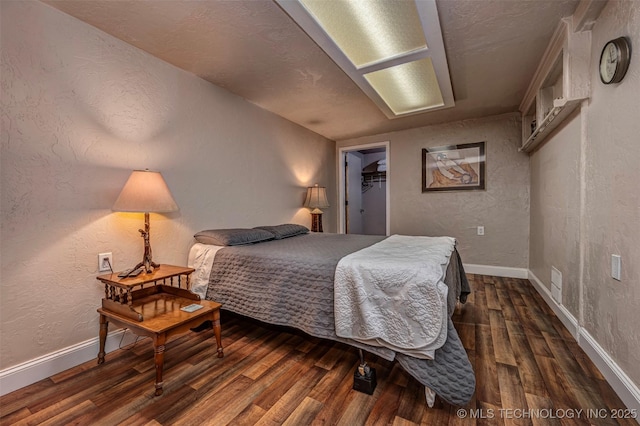 2676 Masters, Sulphur, OK 73086 - bedroom featuring wood finished floors, a textured wall, and a spacious closet