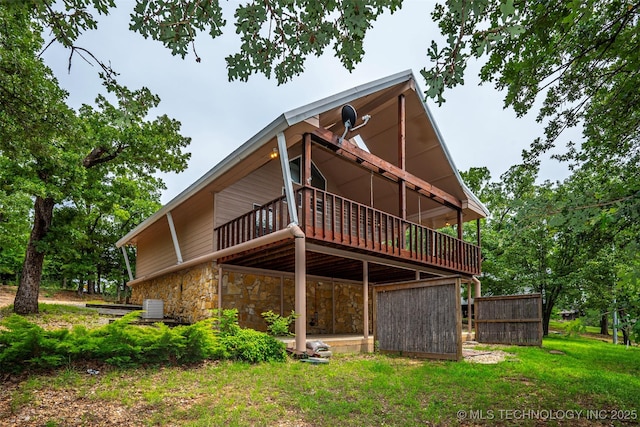 2676 Masters, Sulphur, OK 73086 - rear view of house with a wooden deck and stone siding