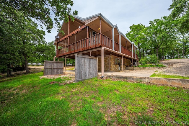 2676 Masters, Sulphur, OK 73086 - back of house featuring a deck, a yard, and stone siding