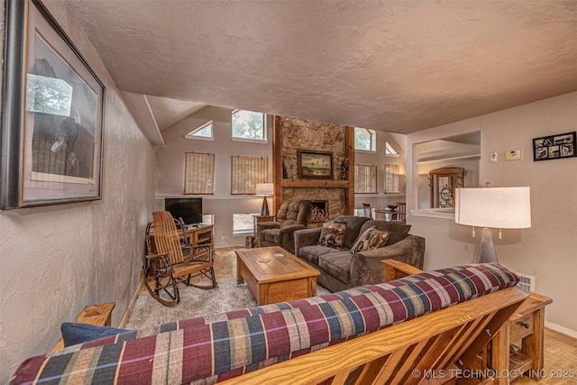 2676 Masters, Sulphur, OK 73086 - living room featuring plenty of natural light, a fireplace, a textured ceiling, a textured wall, and vaulted ceiling