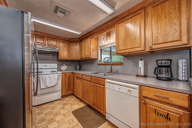 2676 Masters, Sulphur, OK 73086 - kitchen featuring white appliances, under cabinet range hood, and brown cabinetry