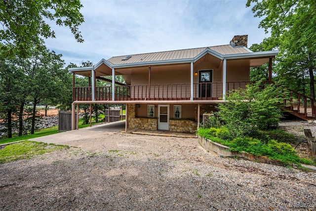 2676 Masters, Sulphur, OK 73086 - view of front of home with a chimney, stone siding, a metal roof, and driveway