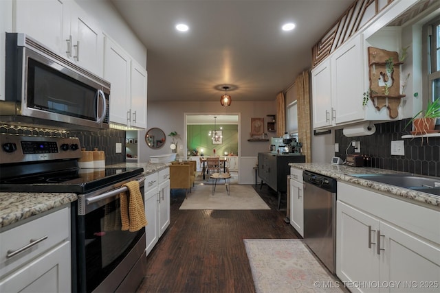 204 W Albuquerque St, Broken Arrow, OK 74011 - kitchen with stainless steel appliances, white cabinets, tasteful backsplash, dark wood-style flooring, and recessed lighting