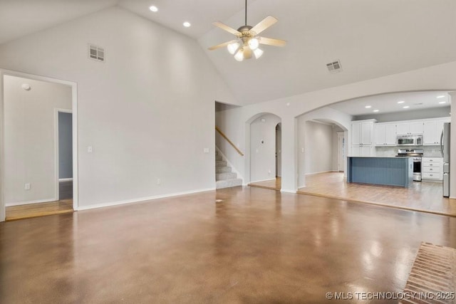 9929 S 85th E Ave, Tulsa, OK 74133 - unfurnished living room featuring high vaulted ceiling, arched walkways, ceiling fan, finished concrete flooring, and recessed lighting