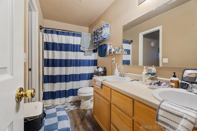 624 S Barclay, Dewey, OK 74029 - full bath with double vanity, wood finished floors, curtained shower, and a textured wall