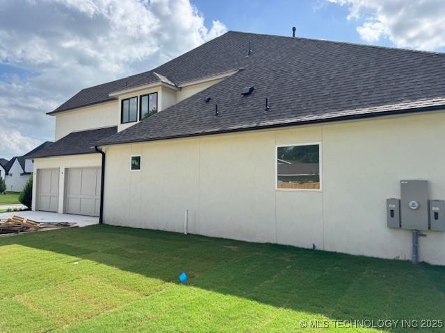 10204 S Florence Ave, Tulsa, OK 74137 - back of property with a shingled roof, stucco siding, and a yard
