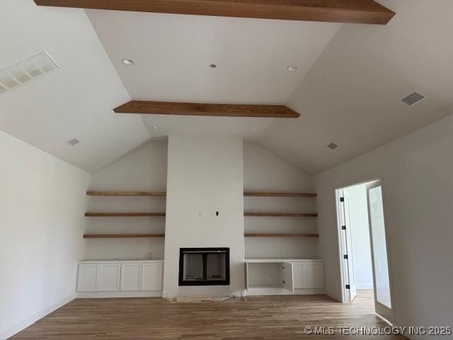 10204 S Florence Ave, Tulsa, OK 74137 - unfurnished living room with wood finished floors, a glass covered fireplace, and built in features