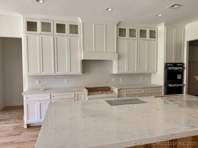 10204 S Florence Ave, Tulsa, OK 74137 - kitchen featuring stainless steel double oven, light stone counters, white cabinetry, and recessed lighting