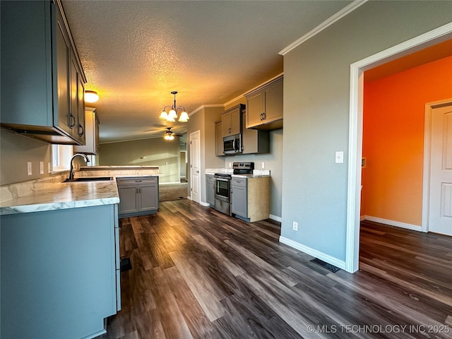 37103 S 4390th Rd, Adair, OK 74330 - kitchen featuring appliances with stainless steel finishes, a chandelier, dark wood-style floors, ornamental molding, and light countertops