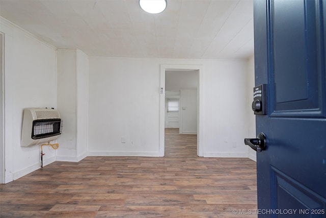 816 S Choctaw Ave, Bartlesville, OK 74003 - unfurnished living room featuring heating unit and wood finished floors