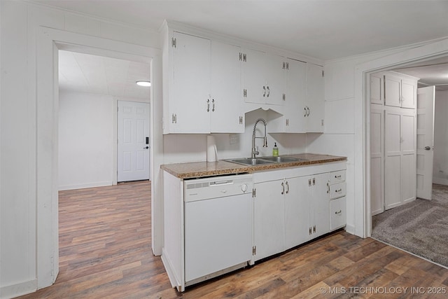 816 S Choctaw Ave, Bartlesville, OK 74003 - kitchen with white dishwasher, wood finished floors, white cabinetry, and ornamental molding