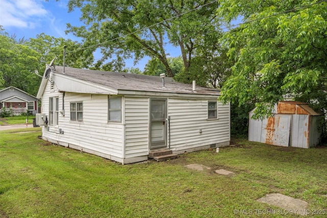816 S Choctaw Ave, Bartlesville, OK 74003 - rear view of house with entry steps, a storage shed, a lawn, and crawl space