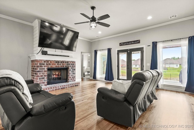 14271 S College Ave, Bixby, OK 74008 - living area with ceiling fan, wood finished floors, crown molding, recessed lighting, and a brick fireplace
