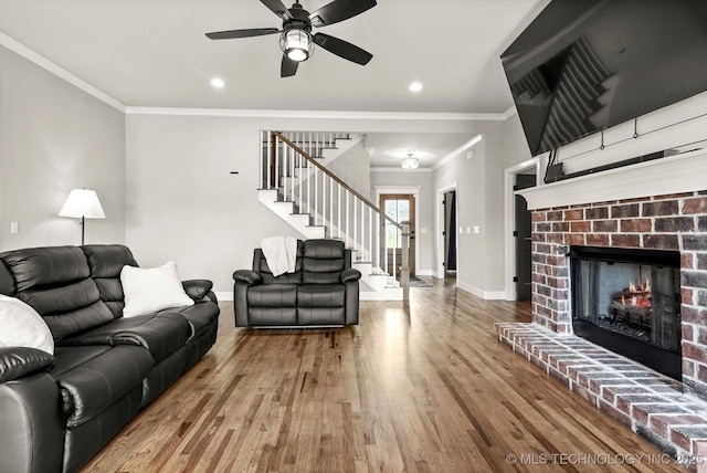 14271 S College Ave, Bixby, OK 74008 - living area featuring stairs, crown molding, wood finished floors, ceiling fan, and a fireplace