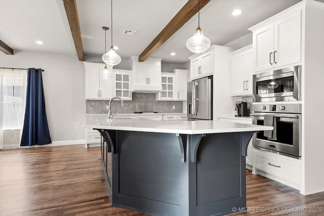 14271 S College Ave, Bixby, OK 74008 - kitchen featuring stainless steel appliances, beam ceiling, dark wood-style floors, glass insert cabinets, and backsplash
