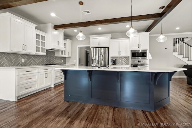 14271 S College Ave, Bixby, OK 74008 - kitchen featuring appliances with stainless steel finishes, beam ceiling, backsplash, white cabinetry, and recessed lighting