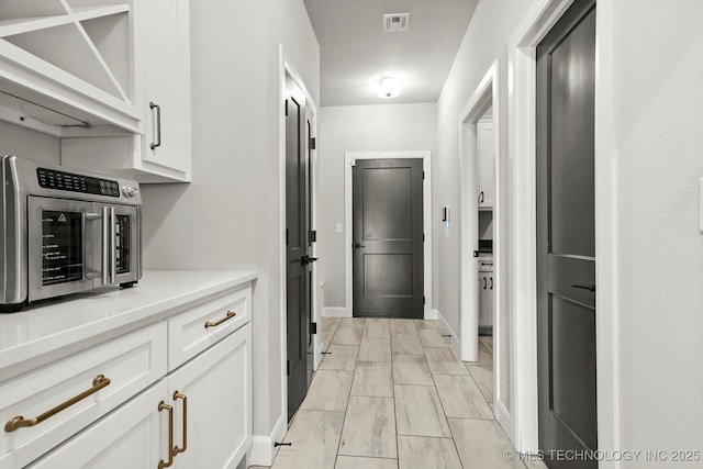 14271 S College Ave, Bixby, OK 74008 - hall featuring light marble finish flooring and baseboards