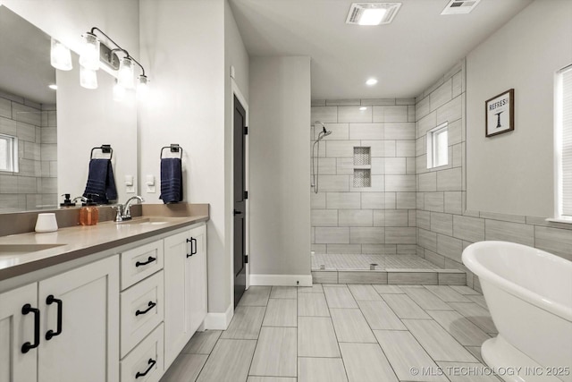 14271 S College Ave, Bixby, OK 74008 - full bath with a shower stall, double vanity, a freestanding bath, and recessed lighting