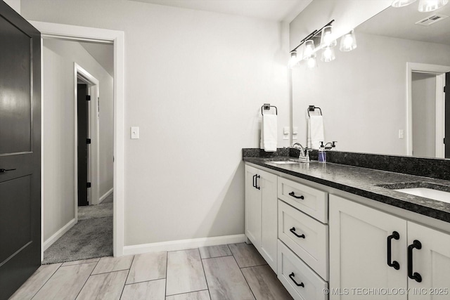 14271 S College Ave, Bixby, OK 74008 - bathroom with double vanity and baseboards