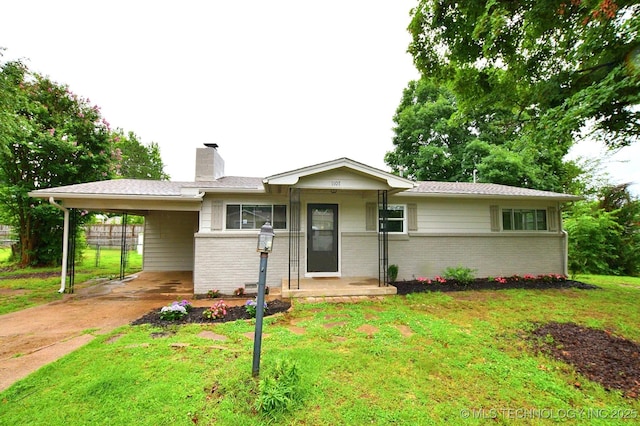 1107 Hillcrest Ave, Tahlequah, OK 74464 - ranch-style home featuring brick siding, a carport, a chimney, and a front yard